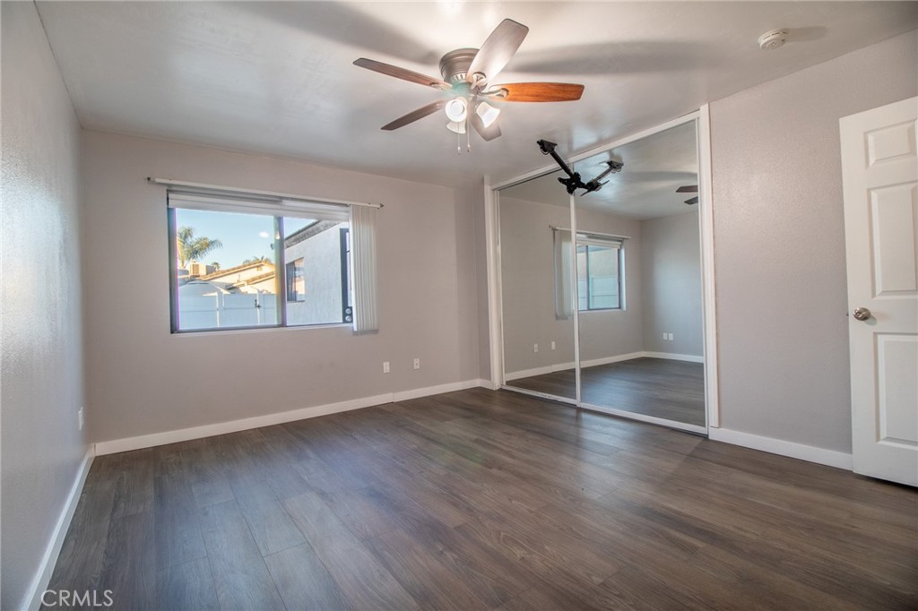 3112 Lynae Way Hemet, CA 92545 - Photo 18 of 26 a view of an empty room with wooden floor and a ceiling fan