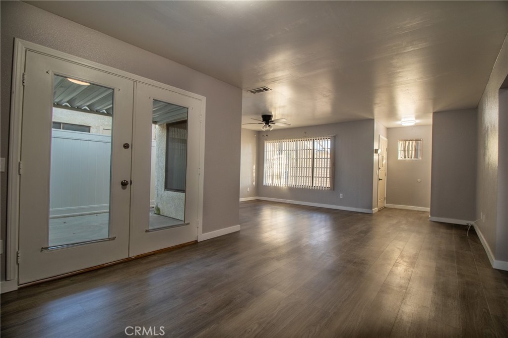3112 Lynae Way Hemet, CA 92545 - Photo 6 of 26 an empty room with wooden floor and windows
