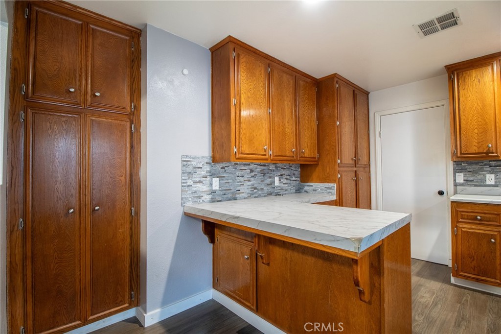 3112 Lynae Way Hemet, CA 92545 - Photo 7 of 26 a kitchen that has a sink and a wooden cabinets in it