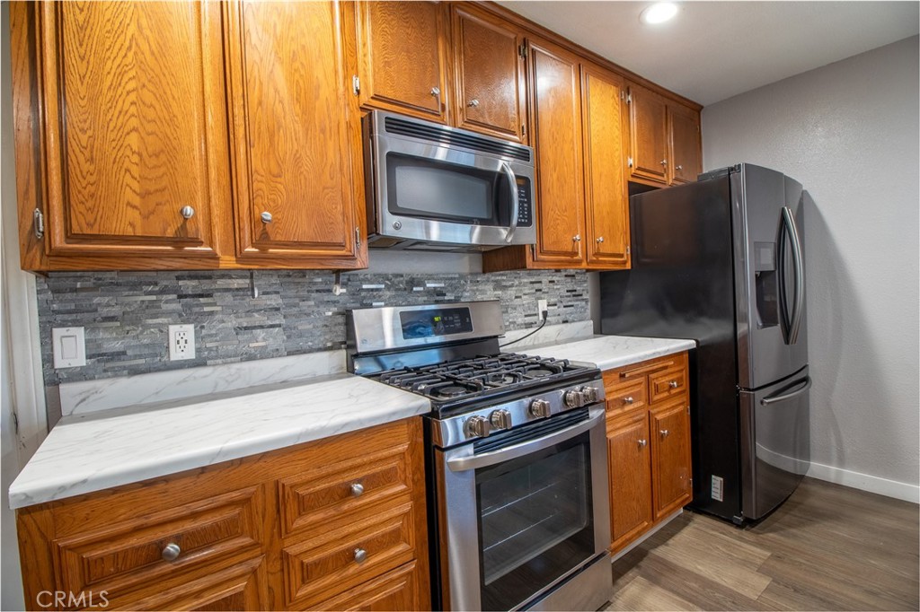 3112 Lynae Way Hemet, CA 92545 - Photo 9 of 26 a kitchen with stainless steel appliances granite countertop a stove a sink and a microwave