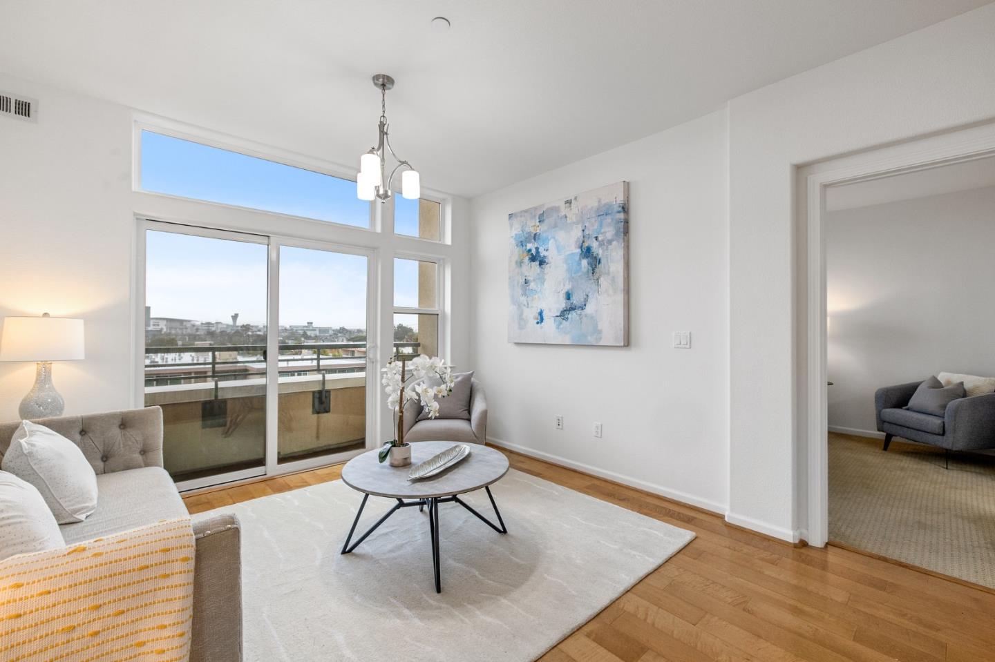 1388 Broadway, Unit 477 Millbrae, CA 94030 - Photo 6 of 33 a living room with furniture a dining table and kitchen view