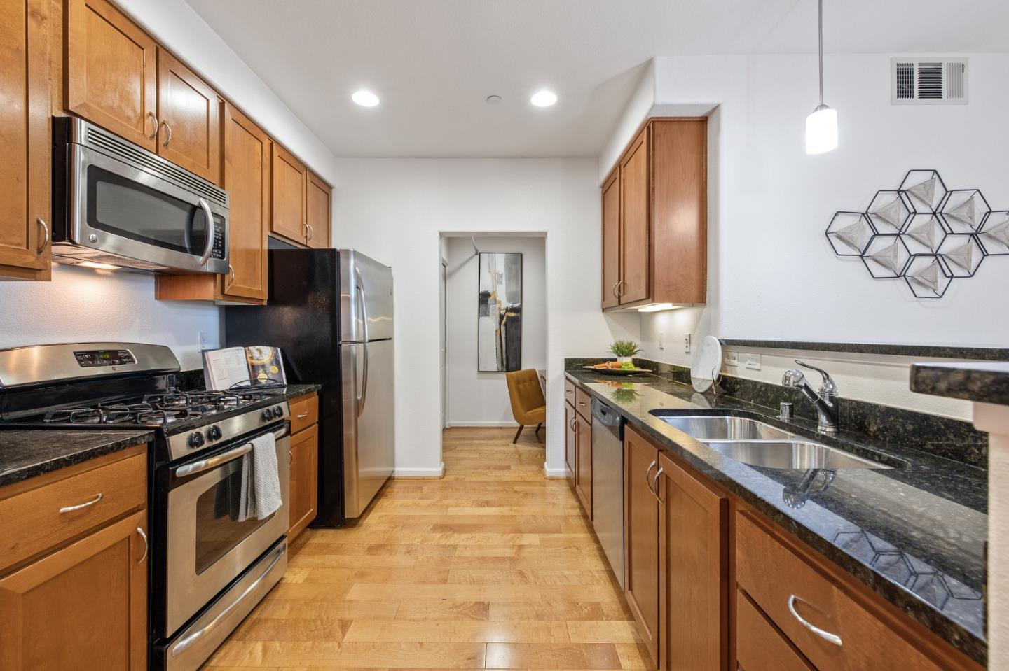 1388 Broadway, Unit 477 Millbrae, CA 94030 - Photo 9 of 33 a kitchen with stainless steel appliances a sink stove and refrigerator
