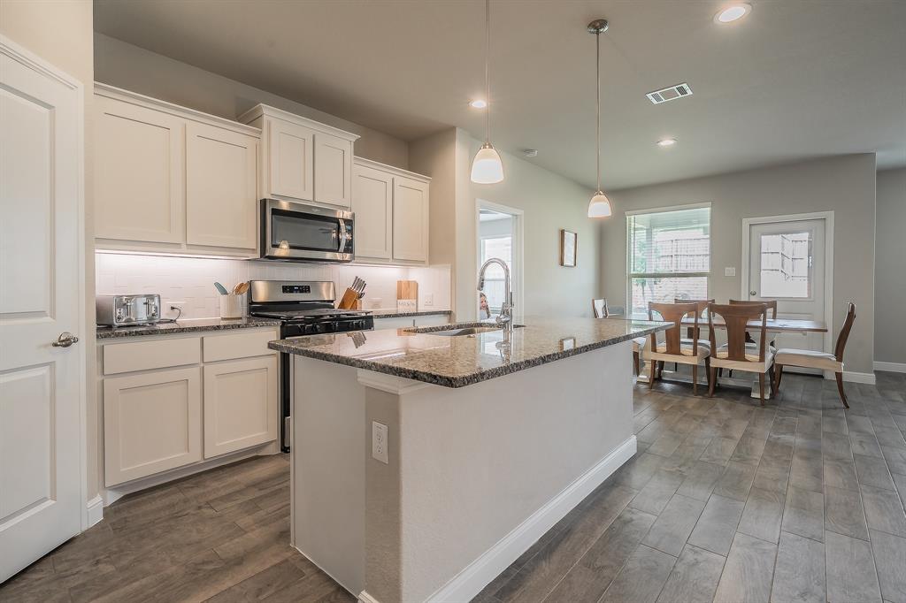 1212 Bosque Lane Weatherford, TX 76087 - Photo 18 of 38 a kitchen with sink cabinets and dining table chair