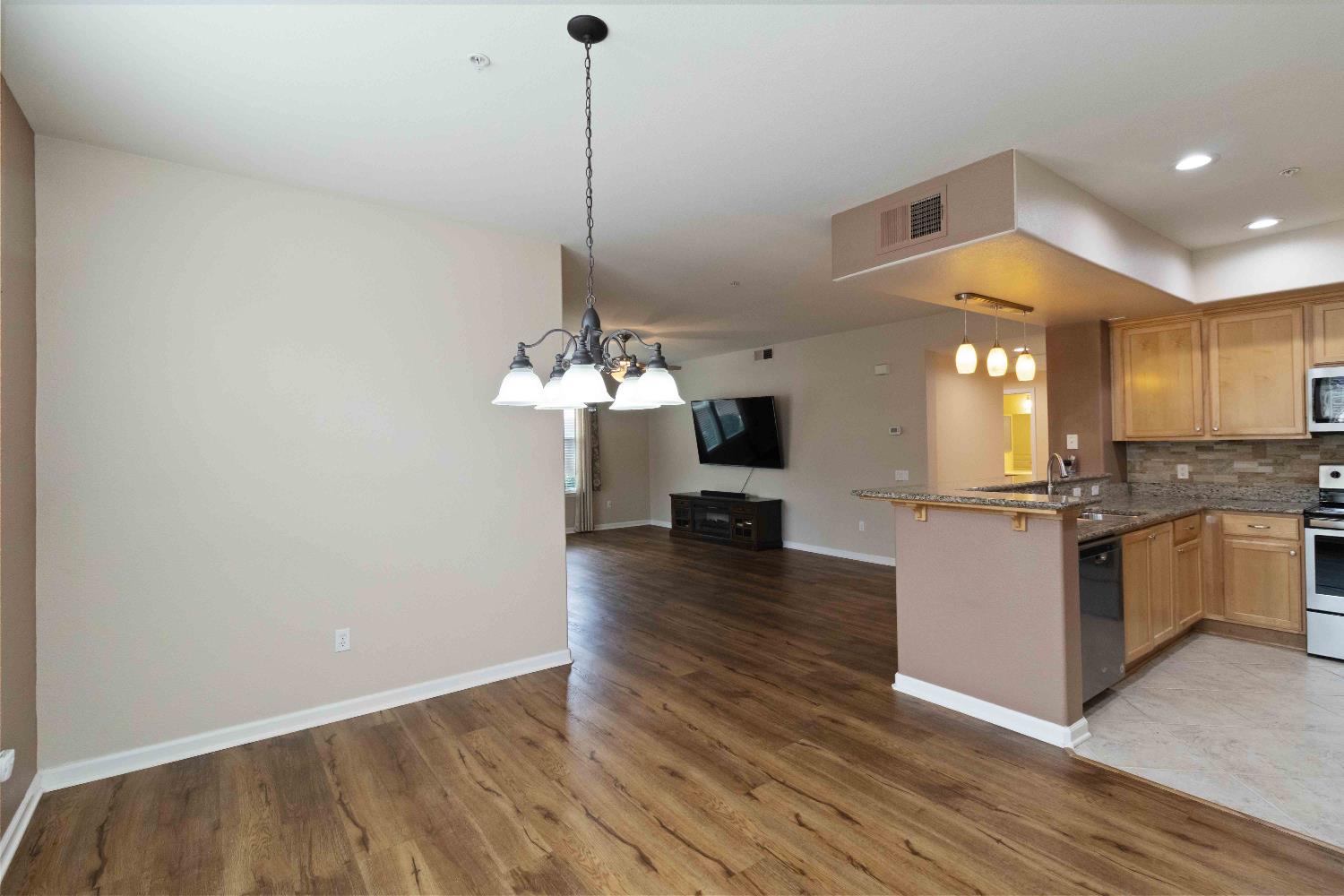 1550 Topanga Lane, Unit 101 Lincoln, CA 95648 - Photo 12 of 27 a view of a kitchen with a sink and a living room area