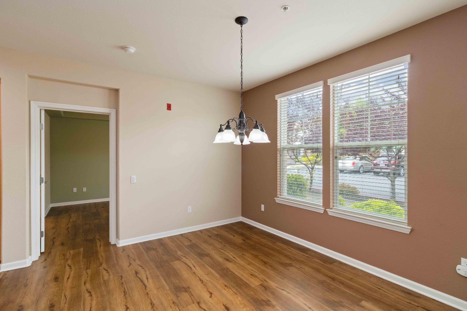 1550 Topanga Lane, Unit 101 Lincoln, CA 95648 - Photo 13 of 27 a view of an empty room with wooden floor and a window