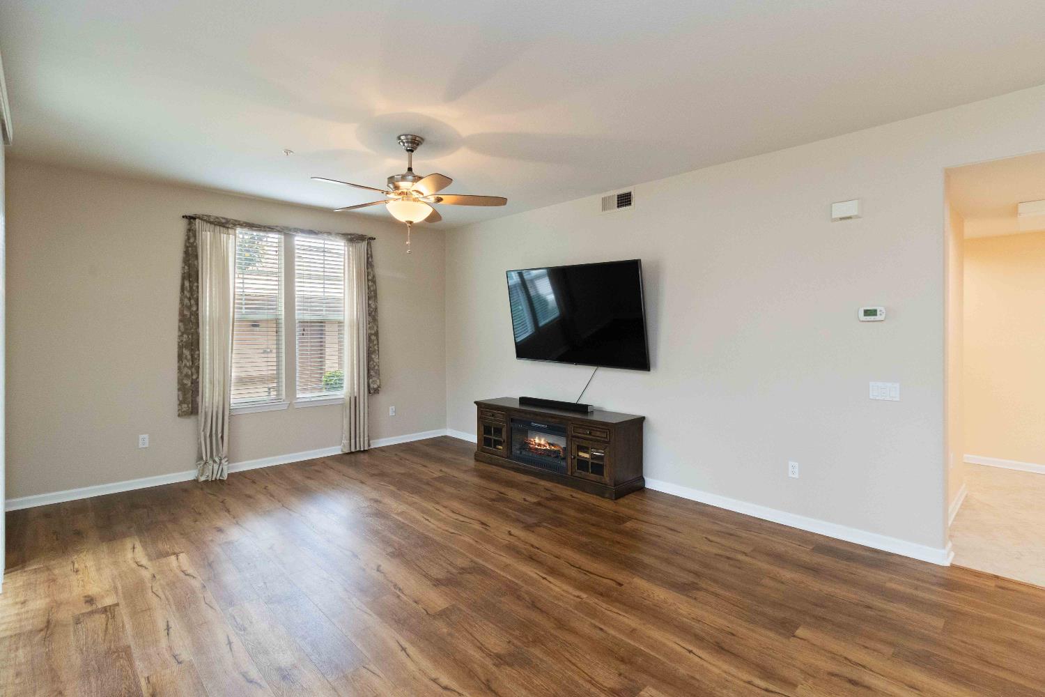 1550 Topanga Lane, Unit 101 Lincoln, CA 95648 - Photo 14 of 27 a living room with furniture and a flat screen tv