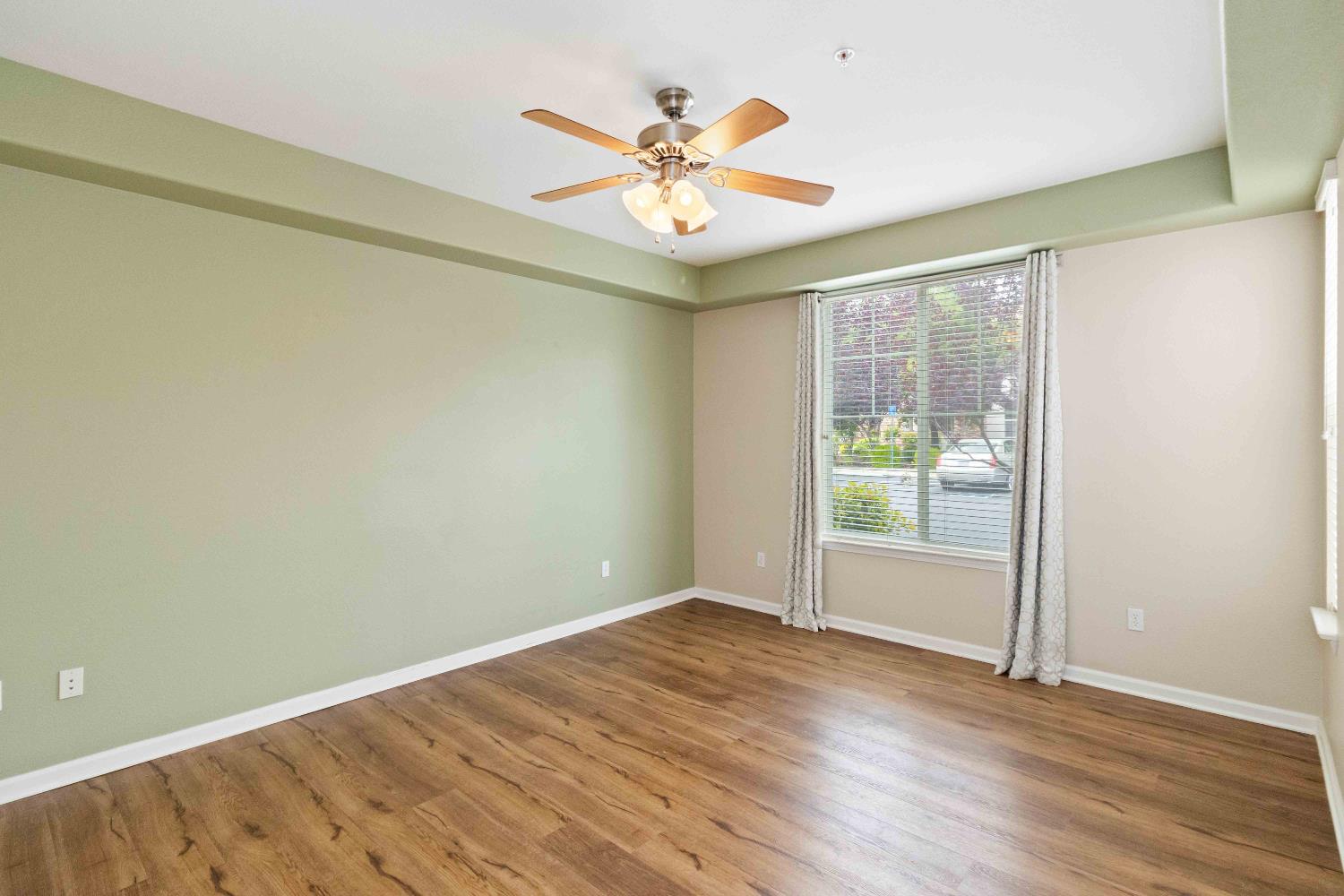 1550 Topanga Lane, Unit 101 Lincoln, CA 95648 - Photo 15 of 27 an empty room with wooden floor and fan