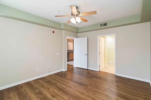 a view of an empty room and wooden floor
