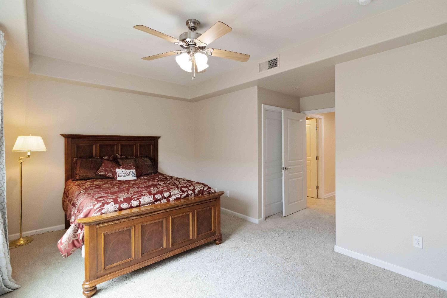1550 Topanga Lane, Unit 101 Lincoln, CA 95648 - Photo 20 of 27 a bedroom with a bed and a chandelier