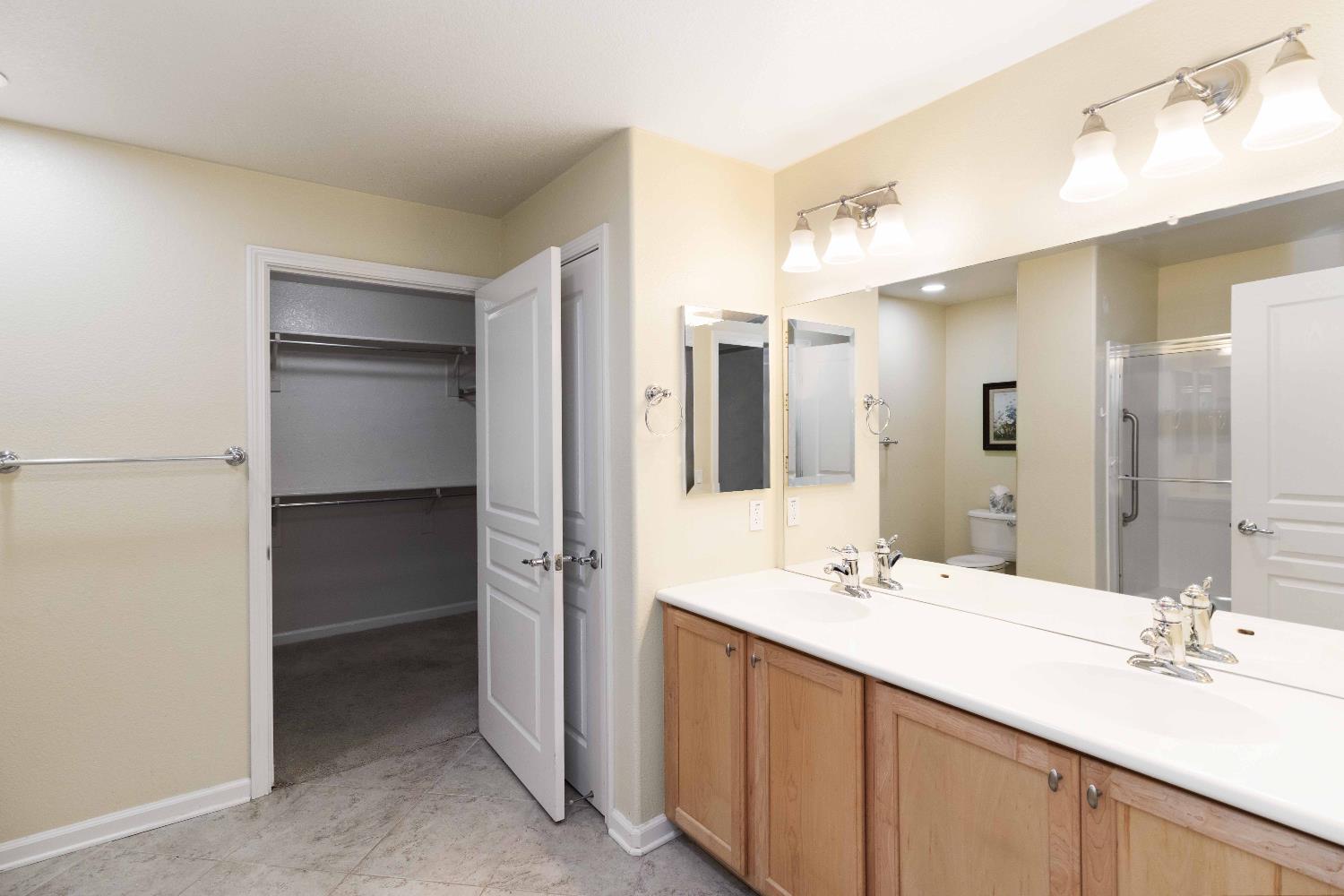 1550 Topanga Lane, Unit 101 Lincoln, CA 95648 - Photo 26 of 27 a bathroom with a double vanity sink mirror and double