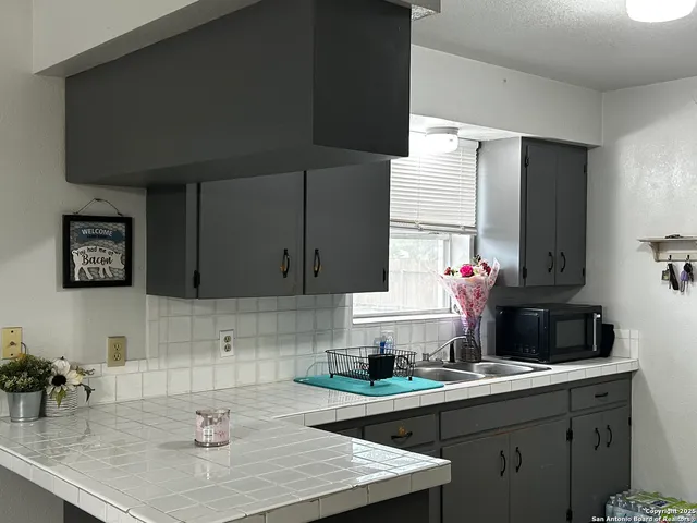 a kitchen with a sink and cabinets