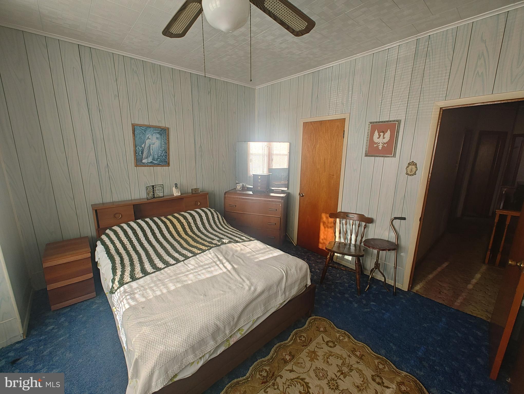 3274 Cedar Street Philadelphia, PA 19134 - Photo 17 of 18 a bedroom with a bed and wooden floor