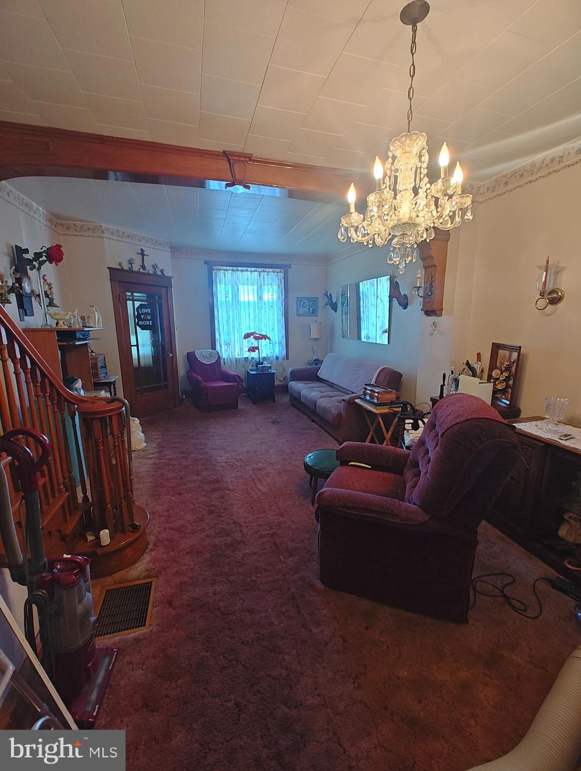 3274 Cedar Street Philadelphia, PA 19134 - Photo 3 of 18 a living room with furniture a chandelier and a chandelier