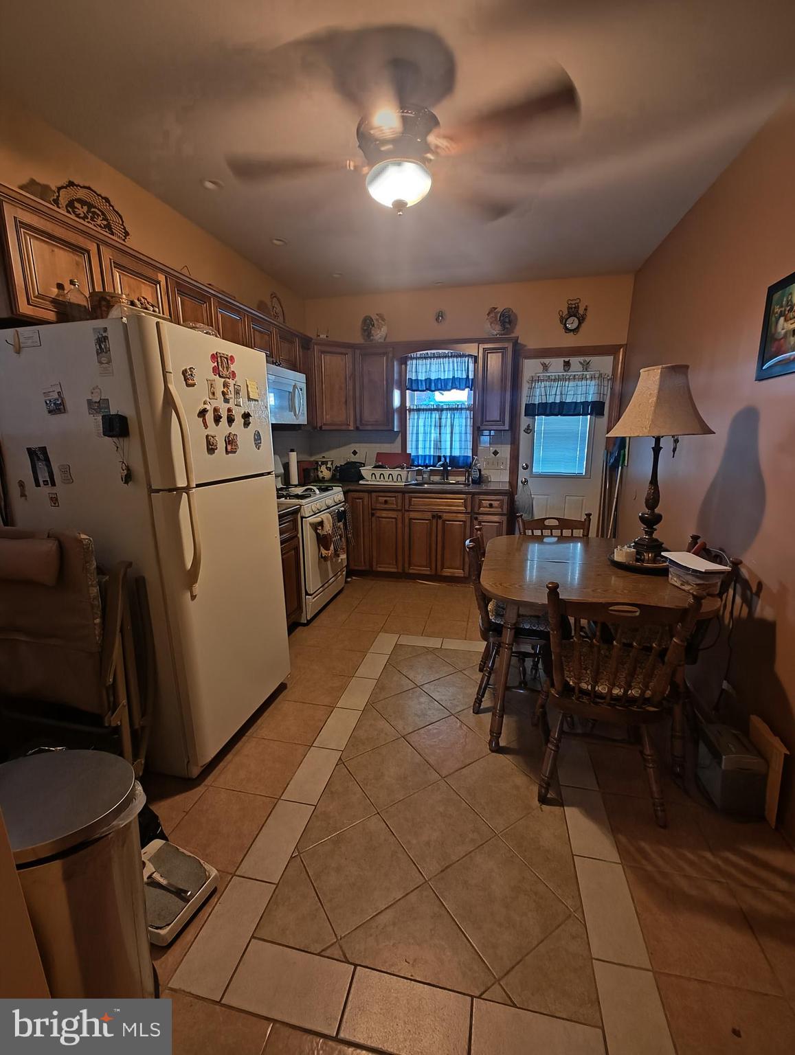 3274 Cedar Street Philadelphia, PA 19134 - Photo 5 of 18 a kitchen with a refrigerator and a table