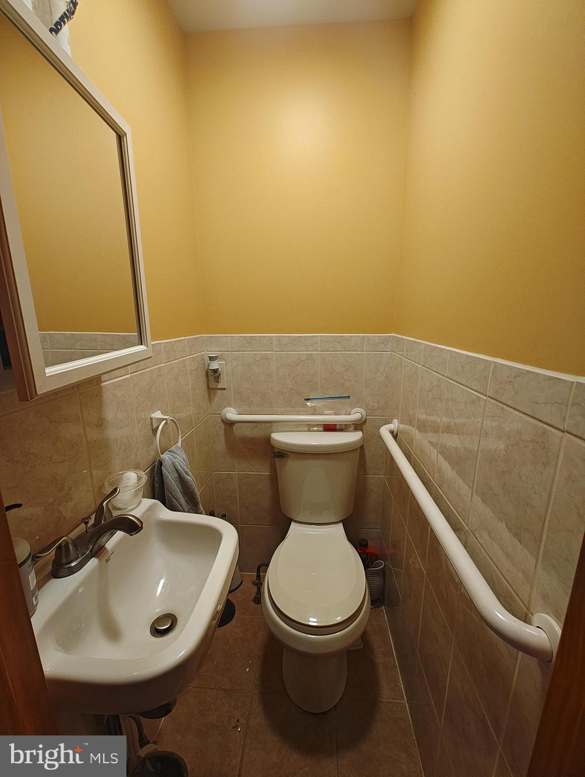 3274 Cedar Street Philadelphia, PA 19134 - Photo 9 of 18 a bathroom with a sink a toilet and a mirror