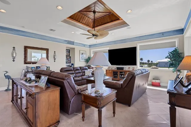 a living room with furniture a flat screen tv and a window