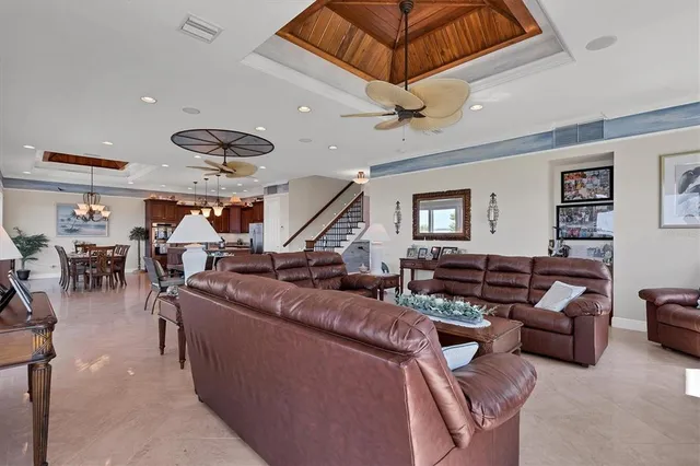 a living room with furniture and a ceiling fan