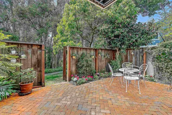a view of a chair and table in backyard of the house