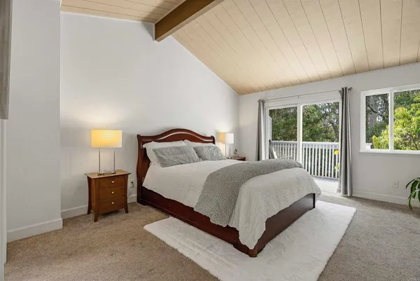 a spacious bedroom with a bed and window