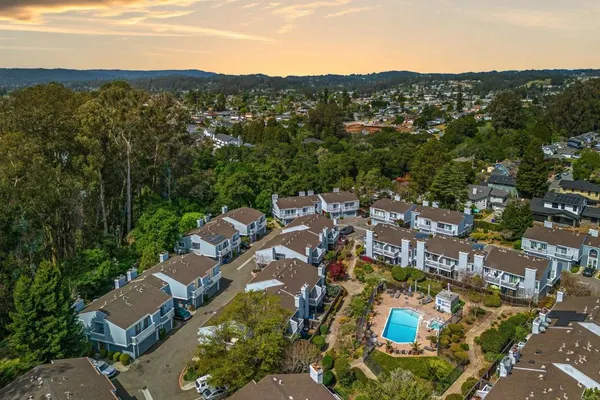 an aerial view of residential houses with outdoor space