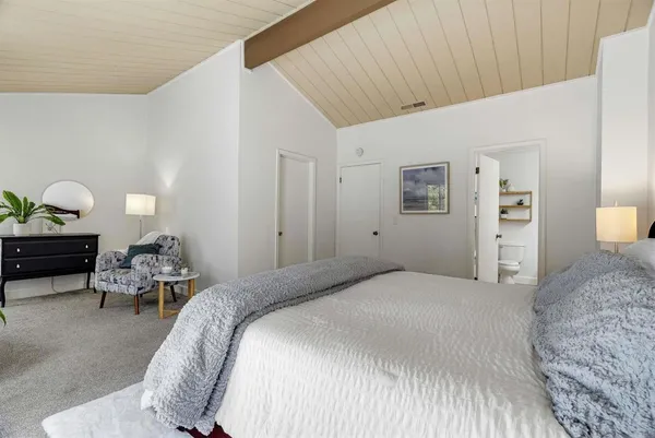 a bedroom with bed and a cabinets