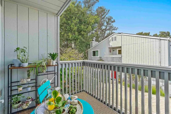 a view of a balcony with furniture