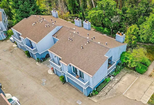 an aerial view of a house with a yard and balcony