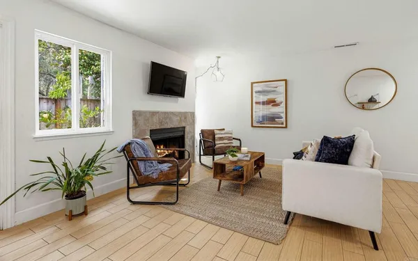 a living room with furniture fireplace and window