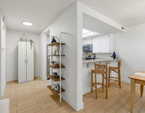 a view of a kitchen with kitchen island dining table and stainless steel appliances