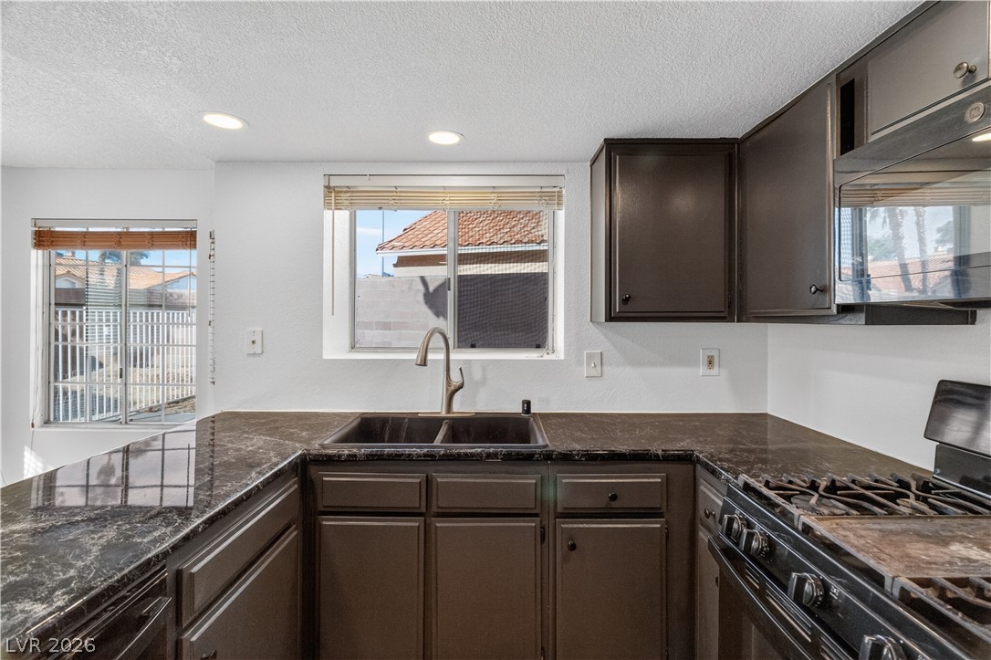 3156 Terrace View Drive Laughlin, NV 89029 - Photo 16 of 94 A well-equipped kitchen featuring dark cabinetry and generous counter space.