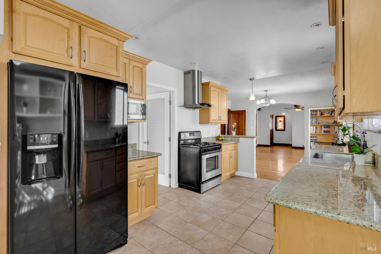 729 First Street Rodeo, CA 94572 - Photo 12 of 35 a kitchen with granite countertop a refrigerator stove and oven