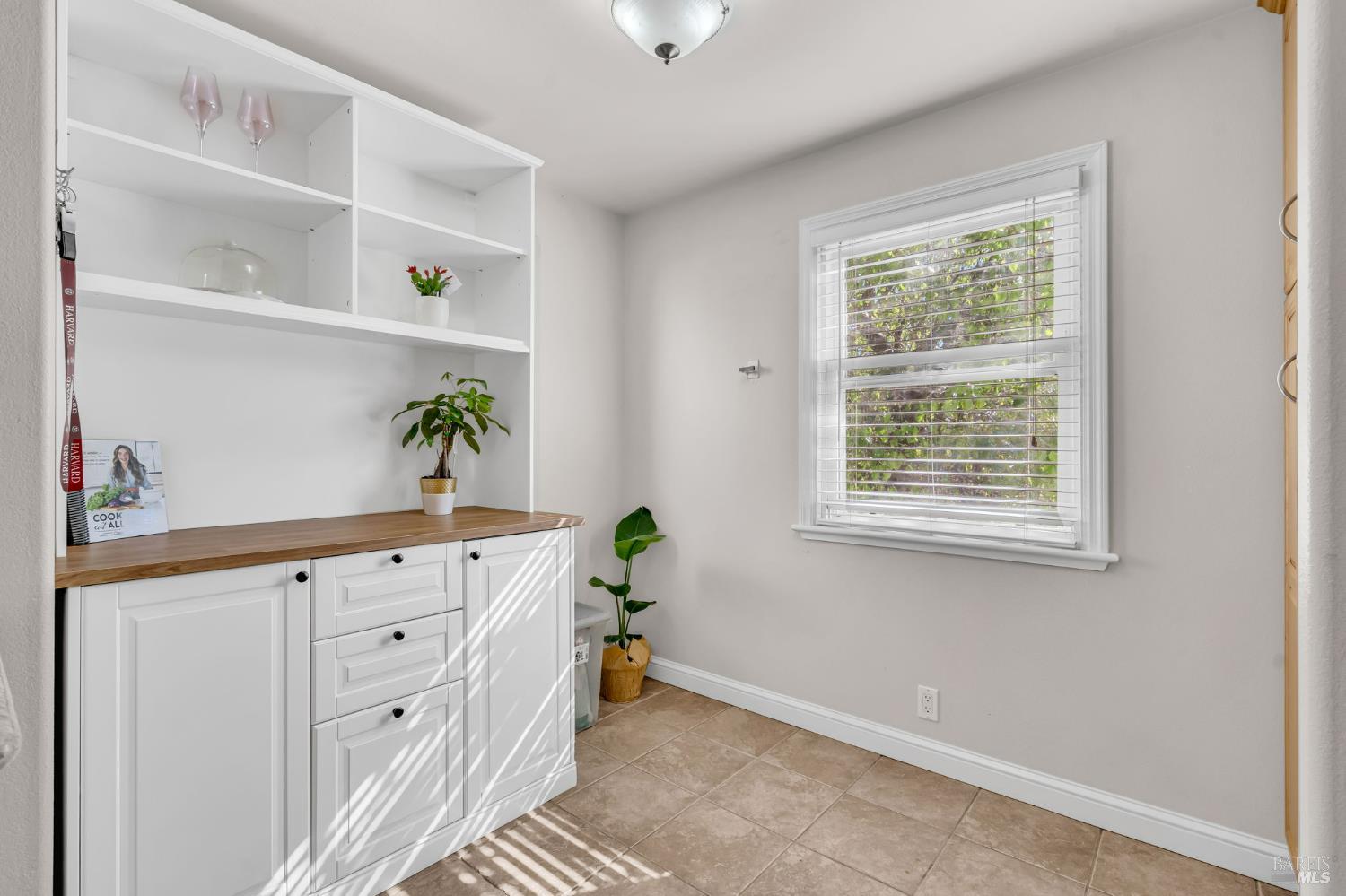 729 First Street Rodeo, CA 94572 - Photo 14 of 35 a kitchen with granite countertop cabinets a potted plant a sink and a window