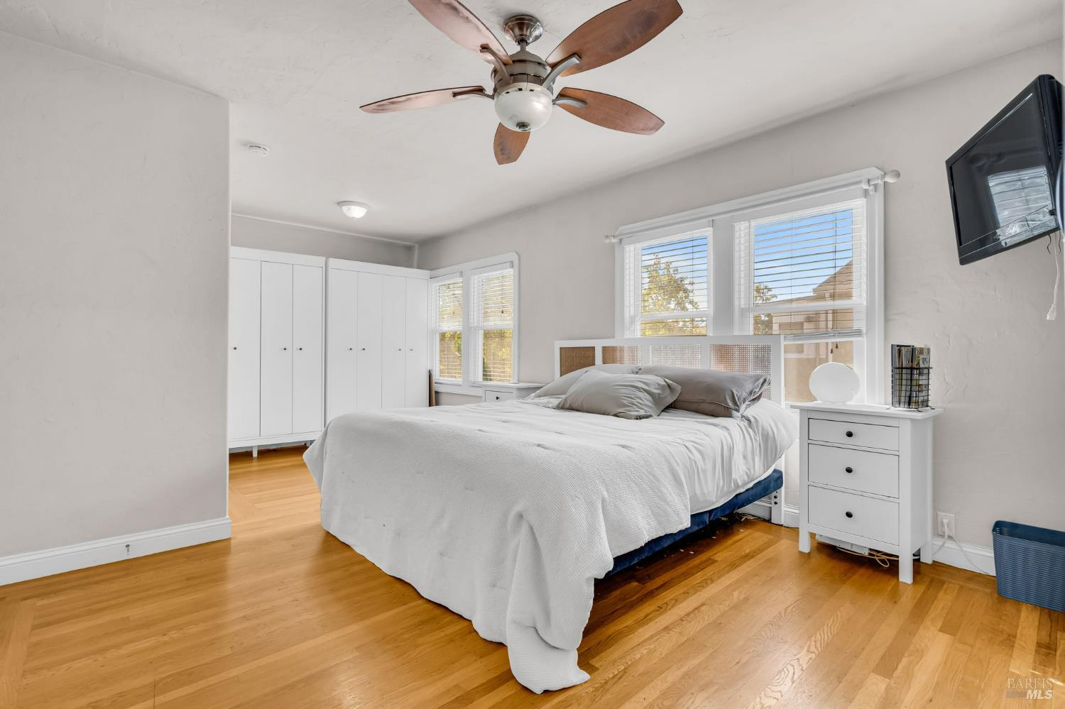 729 First Street Rodeo, CA 94572 - Photo 15 of 35 a spacious bedroom with a bed and a chandelier