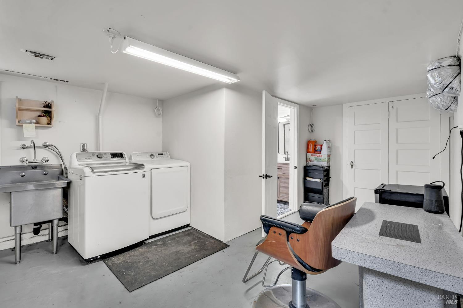 729 First Street Rodeo, CA 94572 - Photo 21 of 35 a room with a chair and white cabinets