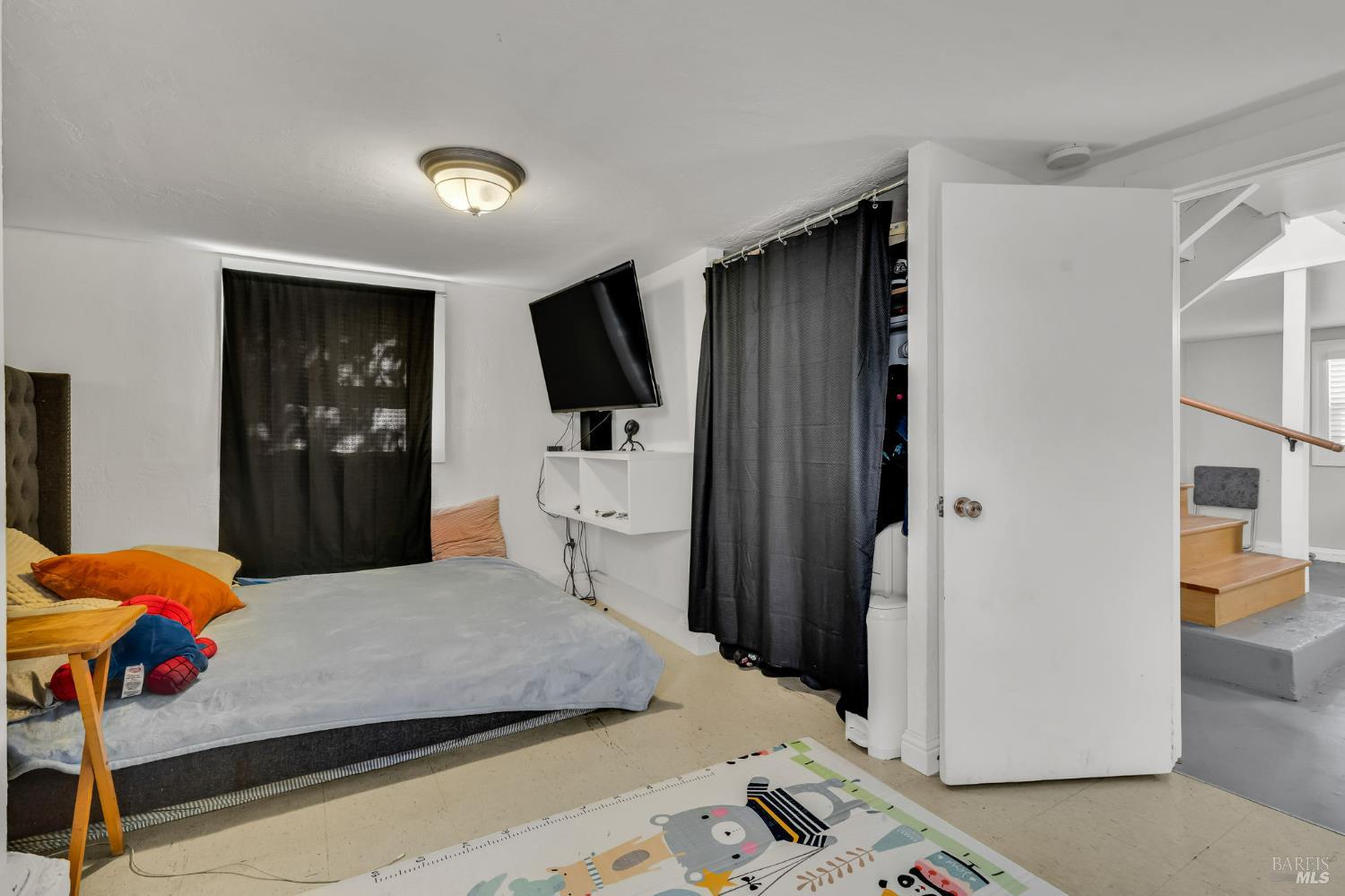 729 First Street Rodeo, CA 94572 - Photo 26 of 35 a bedroom with a bed and a television in it