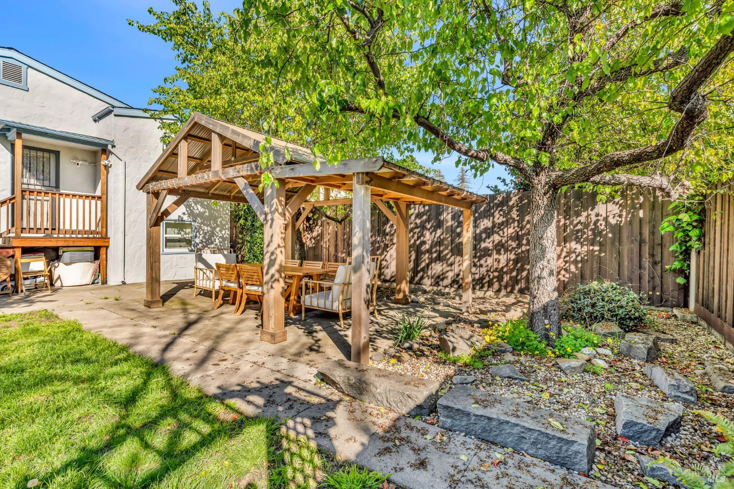729 First Street Rodeo, CA 94572 - Photo 31 of 35 a view of a patio with table and chairs under an umbrella