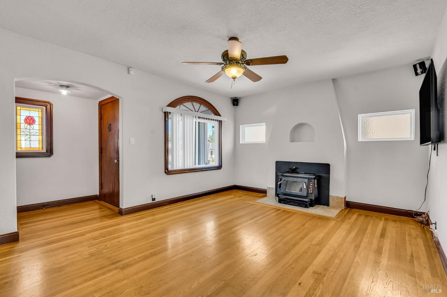 729 First Street Rodeo, CA 94572 - Photo 7 of 35 a view of empty room with a fireplace and wooden floor
