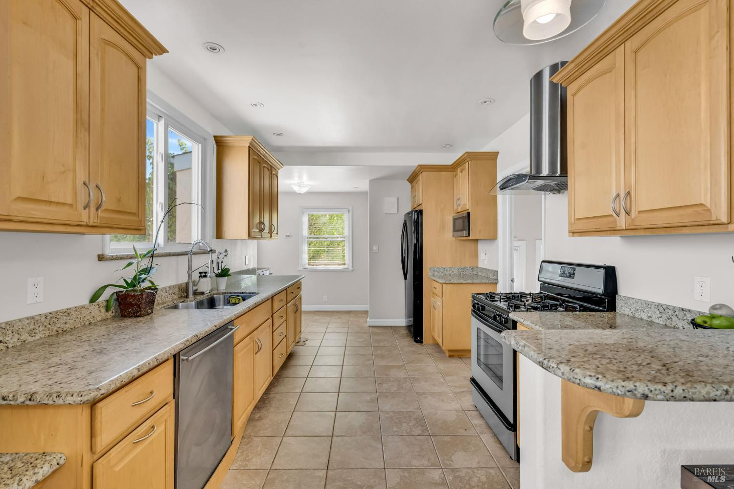 729 First Street Rodeo, CA 94572 - Photo 10 of 35 a kitchen with stainless steel appliances granite countertop a sink stove and refrigerator