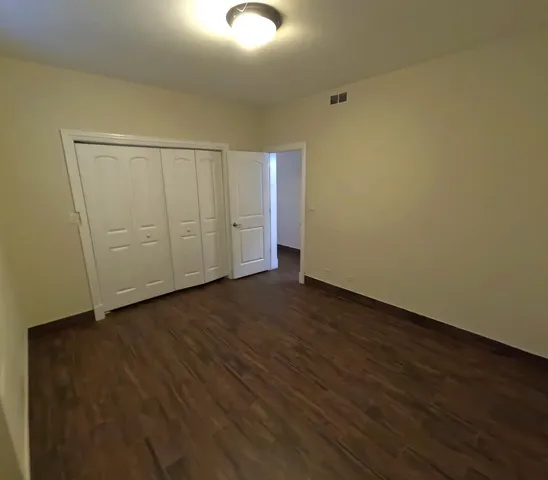 an empty room with wooden floor