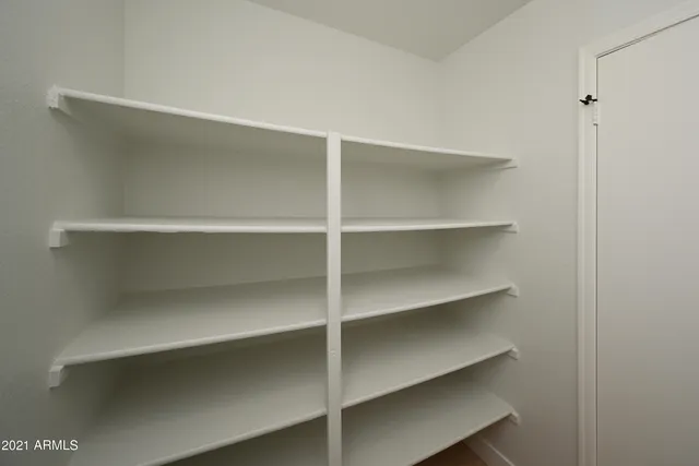 a view of walk in closet with empty racks