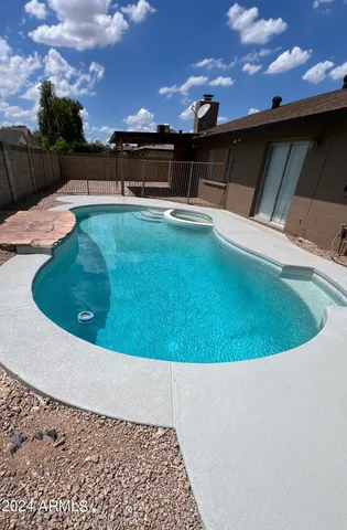 a view of a swimming pool with an outdoor seating