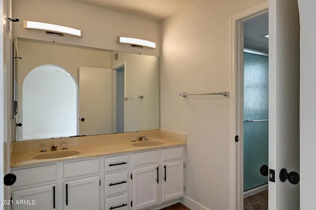 a bathroom with a sink and mirror