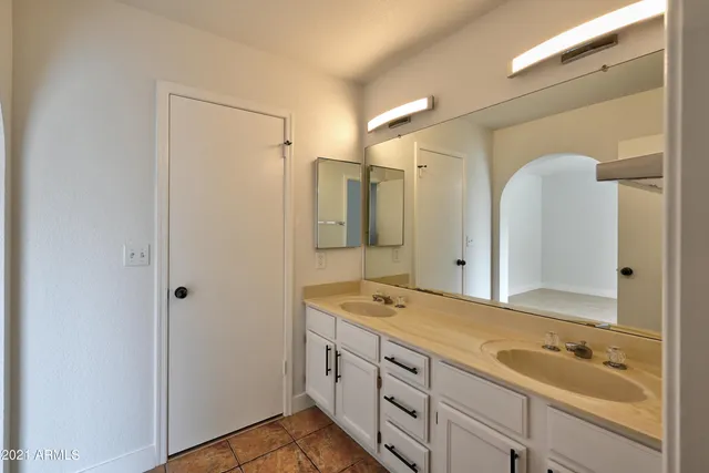 a spacious bathroom with a shower sink and mirror