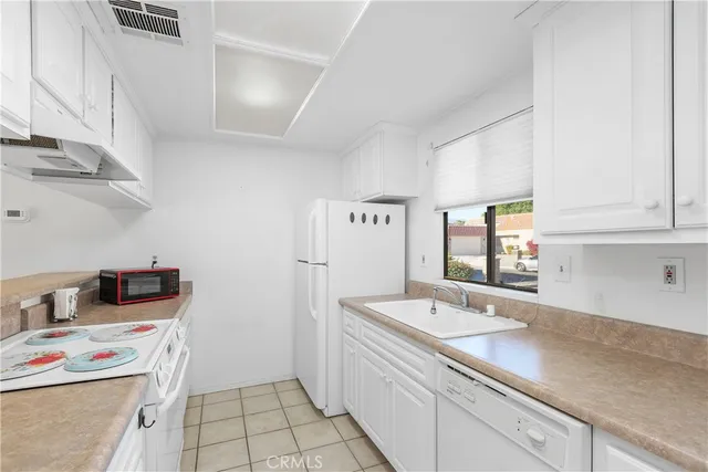 a utility room with cabinets washer and dryer