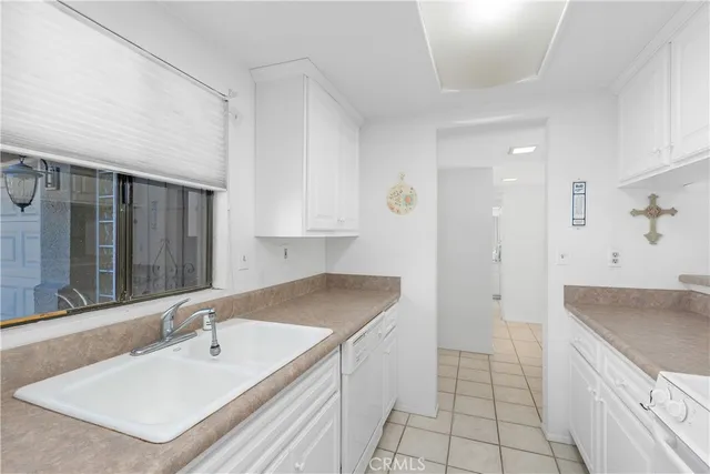 a bathroom with a sink a granite counter top and a tub