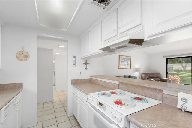 a kitchen that has a sink a stove and a refrigerator