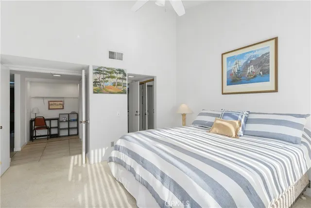 a bedroom with a bed and a desk