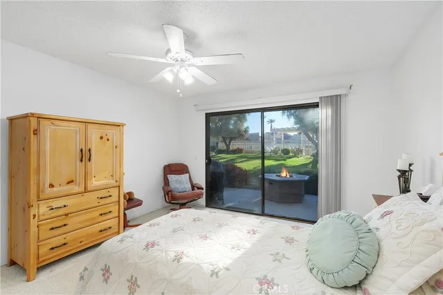 a bedroom with a bed and large mirror