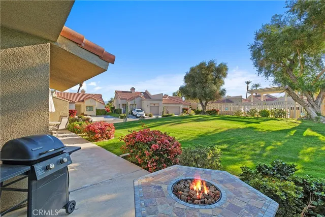 a view of a backyard with table and chairs and potted plants