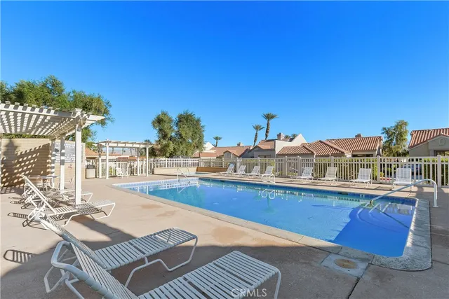 a view of a swimming pool with a lounge chairs